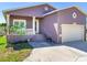 Purple house with a two-car garage and manicured lawn at 3425 Overlook Ne Dr, St Petersburg, FL 33703