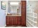 Bathroom with wood vanity, glass block shower, and tiled floors at 3425 Overlook Ne Dr, St Petersburg, FL 33703