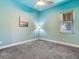 Bedroom with light teal walls, ceiling fan, and carpet at 3425 Overlook Ne Dr, St Petersburg, FL 33703