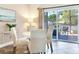 Bright dining area with white table and chairs, near sliding doors to patio at 3425 Overlook Ne Dr, St Petersburg, FL 33703