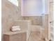 Walk-in bathtub with tiled walls and a built-in seat at 3425 Overlook Ne Dr, St Petersburg, FL 33703