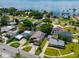 Aerial view of waterfront homes with lush landscaping and solar panels at 3425 Overlook Ne Dr, St Petersburg, FL 33703