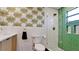 Modern bathroom with green tile shower and updated fixtures at 4216 La Costa Cv # 4216, Bradenton, FL 34210