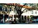 Street view of buildings with shops and a tree, parked car, and bicycle at 4216 La Costa Cv # 4216, Bradenton, FL 34210