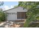 House exterior featuring white siding, a garage, and a screened porch at 3839 Berkshire Ct, Palm Harbor, FL 34684