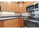 Modern kitchen with stainless steel appliances and ample wood cabinetry at 3839 Berkshire Ct, Palm Harbor, FL 34684