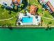 Community pool with surrounding patio and landscaping at 138 1St E St # 106, Tierra Verde, FL 33715