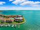 Aerial view of waterfront community with marina, pool, and tennis courts at 138 1St E St # 106, Tierra Verde, FL 33715