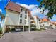 Condo building exterior showcasing parking and water views at 138 1St E St # 106, Tierra Verde, FL 33715