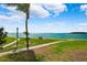 Scenic waterfront view with walkway, bench, and lush landscaping at 138 1St E St # 106, Tierra Verde, FL 33715