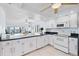 Modern kitchen with white cabinets and appliances at 138 1St E St # 106, Tierra Verde, FL 33715
