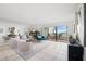 Spacious living room with water views, plush seating, and large windows at 138 1St E St # 106, Tierra Verde, FL 33715