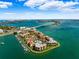 Aerial view of waterfront community with pool, boat slips, and bridge at 138 1St E St # 106, Tierra Verde, FL 33715