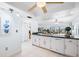 Modern white kitchen with dishwasher and breakfast bar at 138 1St E St # 106, Tierra Verde, FL 33715