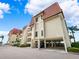 Two-story condo building with tiled roofs and parking underneath at 138 1St E St # 106, Tierra Verde, FL 33715