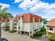 Attractive building exterior with tile roof at 138 1St E St # 106, Tierra Verde, FL 33715