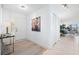 Light and spacious entryway with a console table, artwork, and view to living area at 138 1St E St # 106, Tierra Verde, FL 33715