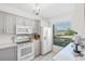 Bright kitchen with white appliances and gray cabinets at 6294 Bahia Del Mar Cir # 115, St Petersburg, FL 33715