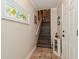 Interior staircase with tile flooring and wall art at 9166 Blind Pass Rd, St Pete Beach, FL 33706