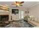 Bright living room features fireplace, comfy seating, and a large TV at 9166 Blind Pass Rd, St Pete Beach, FL 33706