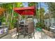 Relaxing patio with table and chairs, great for outdoor dining at 9166 Blind Pass Rd, St Pete Beach, FL 33706