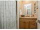 Updated bathroom with shower, vanity, and built-in shelving at 9166 Blind Pass Rd, St Pete Beach, FL 33706