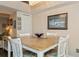 Charming dining area with light wood table and seating for four at 9166 Blind Pass Rd, St Pete Beach, FL 33706