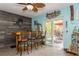 Home bar with three stools, and sliding door to backyard at 9166 Blind Pass Rd, St Pete Beach, FL 33706