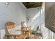 Relaxing patio with wooden chairs and a small table at 9166 Blind Pass Rd, St Pete Beach, FL 33706