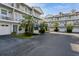 Two-story building with multiple units, garages, and a courtyard at 9166 Blind Pass Rd, St Pete Beach, FL 33706
