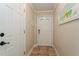Simple entryway with tile flooring and white door at 9166 Blind Pass Rd, St Pete Beach, FL 33706