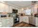 Updated kitchen with stainless steel appliances and farmhouse sink at 9166 Blind Pass Rd, St Pete Beach, FL 33706