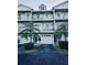 Two-story building with light blue exterior and garage at 9166 Blind Pass Rd, St Pete Beach, FL 33706