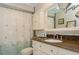 Bathroom with granite countertop, white cabinets, and shower/tub combo at 9166 Blind Pass Rd, St Pete Beach, FL 33706