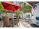 Outdoor patio with table, chairs, and a gas grill at 9166 Blind Pass Rd, St Pete Beach, FL 33706