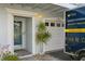 Front entrance and garage with landscaping at 9166 Blind Pass Rd, St Pete Beach, FL 33706