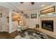 Cozy living room with fireplace and comfortable seating area at 9166 Blind Pass Rd, St Pete Beach, FL 33706