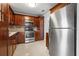 Modern kitchen with stainless steel appliances and wood cabinets at 5660 80Th N St # A208, St Petersburg, FL 33709