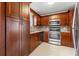 Modern kitchen with stainless steel appliances and wood cabinets at 5660 80Th N St # A208, St Petersburg, FL 33709
