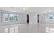 Bright living room with large windows and tile floors at 5660 80Th N St # A208, St Petersburg, FL 33709