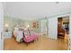 Bright bedroom with white bedding, patterned wallpaper, and a pink accent chair at 50 Coe Rd # 331, Belleair, FL 33756