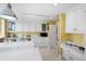 Spacious kitchen with white cabinets, marble countertops, and breakfast bar at 50 Coe Rd # 331, Belleair, FL 33756