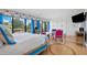 Main bedroom with sitting area, golf course view, and blue accents at 50 Coe Rd # 331, Belleair, FL 33756