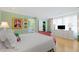 Spacious bedroom with white bedding, green wallpaper, and built-in white dresser at 50 Coe Rd # 331, Belleair, FL 33756