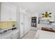 Modern white kitchen with ample storage and yellow backsplash at 50 Coe Rd # 331, Belleair, FL 33756