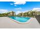 Inviting community pool with surrounding lounge chairs and lush landscaping at 50 Coe Rd # 331, Belleair, FL 33756