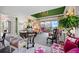 Living area with colorful decor, a round table and access to balcony at 50 Coe Rd # 331, Belleair, FL 33756