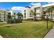 Modern condo building with lush landscaping and convenient walkways at 50 Coe Rd # 331, Belleair, FL 33756