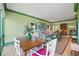 Charming dining area with a wooden table and white chairs, overlooking a lush green view at 50 Coe Rd # 331, Belleair, FL 33756