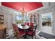 Bright dining room with red ceiling, floral wallpaper and view to adjacent sitting area at 50 Coe Rd # 331, Belleair, FL 33756